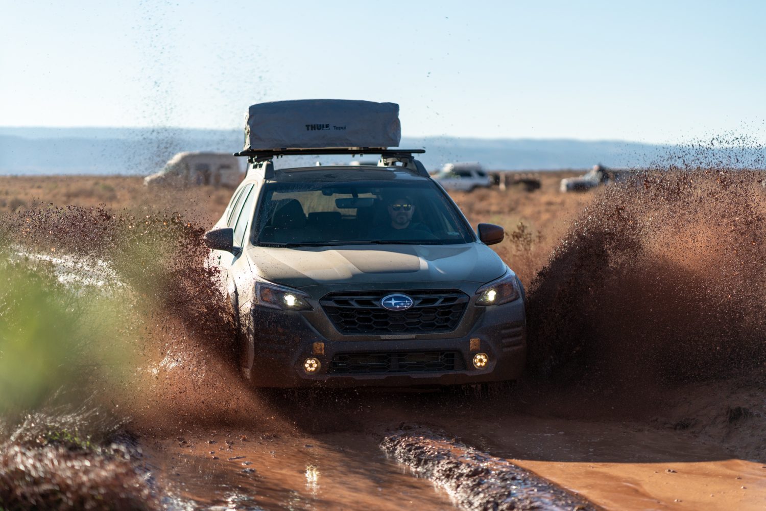 subaru wilderness driving through mud on overlanding trip